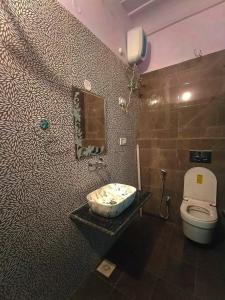 a bathroom with a toilet and a sink at Friend India in Jaipur