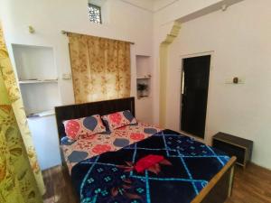 a bedroom with a bed with a quilt and pillows at Friend India in Jaipur