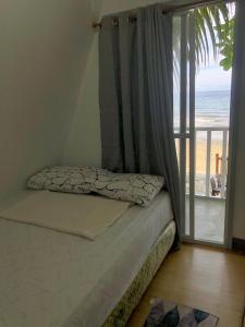 a bedroom with a bed with a view of the beach at Hidden View Resort GovGen 