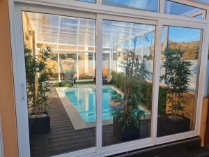 a window view of a house with a swimming pool at Casa Particular das Pedras in Vila Nova de Gaia