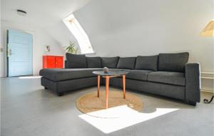 a living room with a couch and a table at Eight-Bedroom Holiday Home In Glesborg in Glesborg