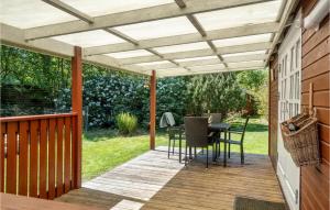 a pergola on a deck with a table and chairs at 1 Bedroom Beautiful Home In Vig in Vig +12 photos