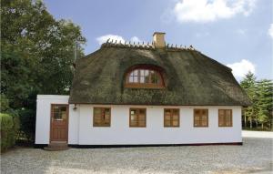 a small white house with a thatched roof at Three-Bedroom Holiday Home In Bagenkop in Bagenkop