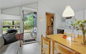 a kitchen and dining room with a table and chairs at 2 Bedroom Amazing Home In Nexø in Neksø +17 photos