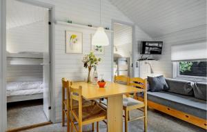 a dining room and living room with a table and chairs at 2 Bedroom Amazing Home In Nexø in Neksø