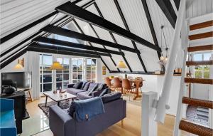 a living room with a couch and a table at Holiday Home Havklitvej Ringkøbing Vi in Ringkøbing