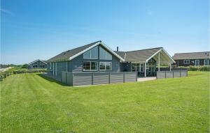 a house with a green lawn in front of it at Beach Front Home In Bogense With Sauna in Bogense