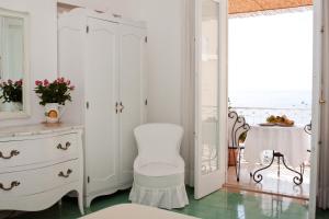 
a white toilet sitting next to a window in a room at Villa La Tartana in Positano
