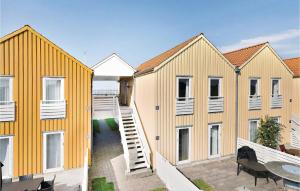 a row of yellow houses with a patio at Two-Bedroom Apartment In Rudkobing in Rudkøbing +16 photos