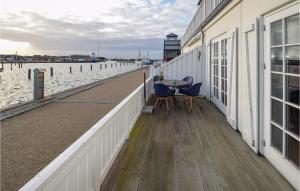 a dock with a table and chairs next to the water at Apartment Bagenkop 27 in Bagenkop