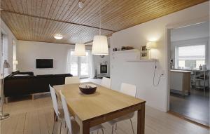 una sala da pranzo e un soggiorno con tavolo e divano. di Cozy Home In stermarie With Kitchen a Østermarie