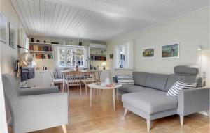a living room with a couch and chairs and a table at Mosehytten in Neksø