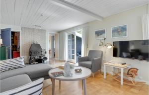 a living room with a couch and a table at Mosehytten in Neksø