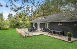 a backyard of a house with a wooden deck at 3 Bedroom Gorgeous Home In Rdby in Rødbyhavn