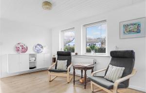 a living room with two chairs and a table at Gorgeous Home In Allinge With Sauna in Allinge