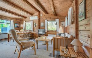 a living room and dining room in a log cabin at Nice Home In Vggerlse With Wifi in Bøtø By