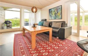 a living room with a couch and a table at Holiday Home Lundvej Sydals Denm in Vollerup +10 photos