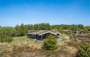 a house on top of a hill with trees at Stunning Home In Rm With 5 Bedrooms, Sauna And Wifi in Bolilmark