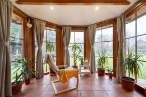 ein Wohnzimmer mit Fenstern und Pflanzen in der Unterkunft Hazelnut Pool House - Happy Rentals in Ludbreg