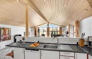a kitchen with a sink and a wooden ceiling at Stunning Home In Rm With 5 Bedrooms, Sauna And Wifi in Bolilmark