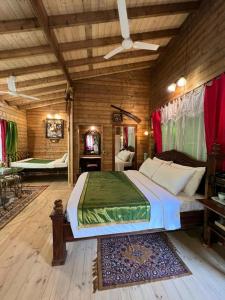 a bedroom with a large bed in a wooden room at Indeco Hotels Swamimalai in Kumbakonam