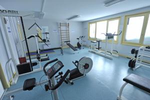 a gym with several treadms and machines in a room at VVF Haute-Loire Les Estables in Les Estables