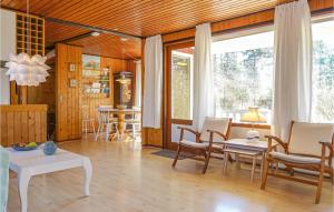 ein Wohnzimmer mit Tisch und Stühlen in der Unterkunft Awesome Home In Aakirkeby With Kitchen in Vester Sømarken
