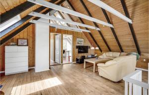 a living room with a couch and a table at Cozy Home In Ebeltoft With Kitchen in Ebeltoft