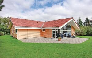 a small house with a red roof and a patio at Beautiful Home In Sklskr With 4 Bedrooms, Sauna And Wifi in Skælskør