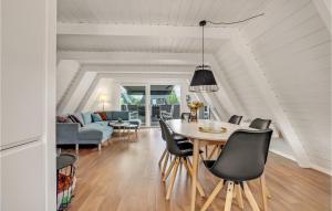 a dining room and living room with a table and chairs at Nice Home In Fars With Wifi And 2 Bedrooms in Farsø