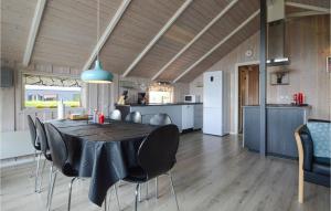 a dining room and kitchen with a table and chairs at Four-Bedroom Holiday Home In Hejls in Hejls