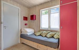 Habitación pequeña con cama y ventana en Awesome Home In Vggerlse With Kitchen, en Bøtø By