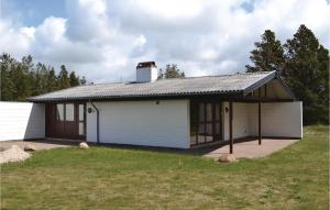 una casa bianca con tetto di gamberetti di Holiday Home Fyrrekrogen Nørre Nebel Iii a Lønne Hede