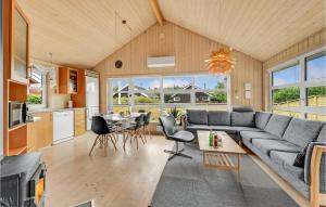 a living room with a couch and a table at Two-Bedroom Holiday Home In Hemmet in Hemmet