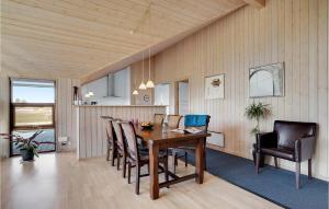 a dining room with a wooden table and chairs at Awesome Home In Ansager With Wifi in Ansager