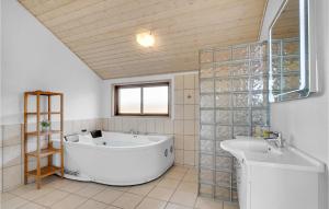 a large bathroom with a tub and a sink at Awesome Home In Ansager With Wifi in Ansager +22 photos
