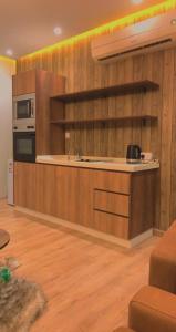 a kitchen with wooden walls and a counter with a microwave at الكوخ العثماني غرفة وصالة وفناء خارجي وسيع in Jeddah