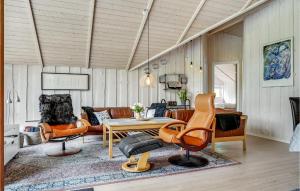 a living room with orange chairs and a table at Holiday Home Glesborg With A Fireplace 02 in Fjellerup