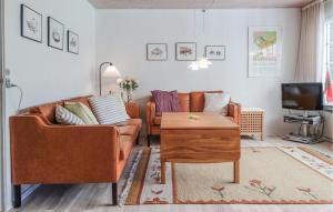 a living room with a couch and a table at 4 Bedroom Lovely Home In Nexø in Neksø