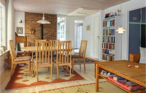 a dining room with a table and chairs at 4 Bedroom Lovely Home In Nexø in Neksø