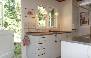 a kitchen with white cabinets and a sink at 4 Bedroom Lovely Home In Nexø in Neksø
