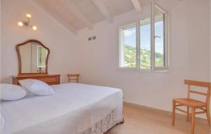 a bedroom with a bed with a mirror and a chair at La Casa Gialla in Framura
