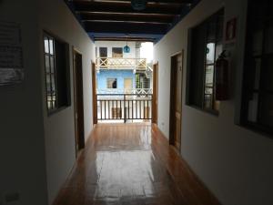 an empty hallway with a view of a building at Hostal Yaku Montañita in Montañita
