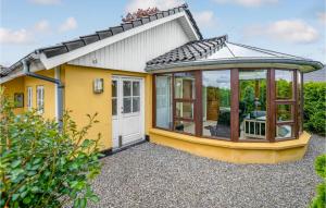 a yellow house with a conservatory on it at Stunning Home In Haderslev With Wifi in Haderslev +10 photos