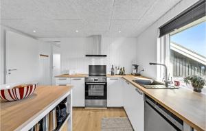 a kitchen with a sink and a stove top oven at Nice Home In Tarm With Kitchen in Hemmet +27 photos