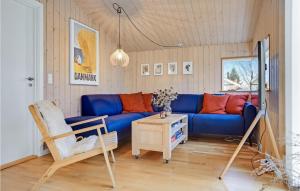 a living room with a blue couch and a chair at Beautiful Home In Knebel in Knebel
