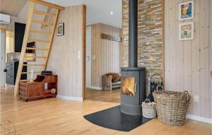 a fireplace in a living room with a staircase at Beautiful Home In Knebel in Knebel