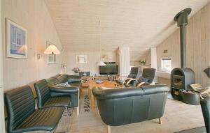 a living room with leather furniture and a fireplace at 4 Bedroom Lovely Home In Nex in Snogebæk