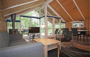 YderbyにあるAwesome Home In Sjllands Odde With 3 Bedrooms, Sauna And Wifiのリビングルーム(ソファ、テレビ、テーブル付)