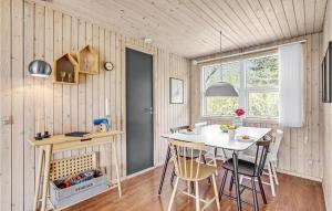 a kitchen with a table and chairs in a room at Holiday Home Gøgeurtvej Væggerløse X in Marielyst